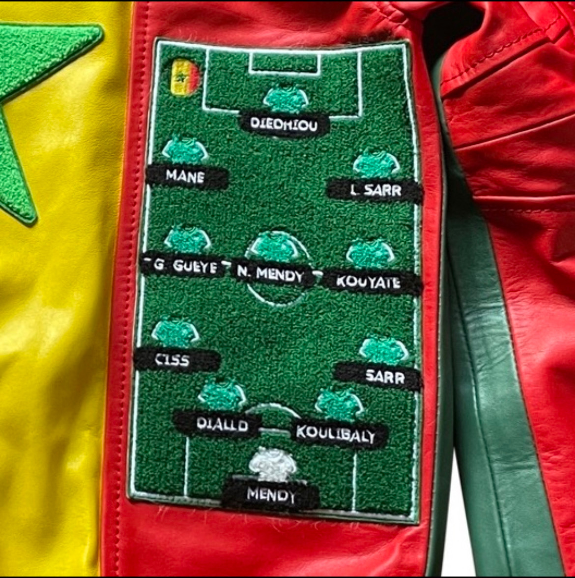 Senegal Championship Leather Jacket – Close-up of embroidered starting lineup football pitch design