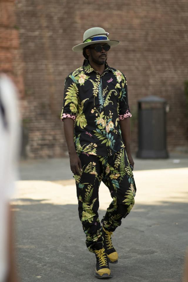 Model wearing the Flora Power Shirt and matching pants – designer floral set styled with hat and boots